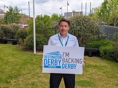 David Fletcher holding an 'I'm backing Derby' sign
