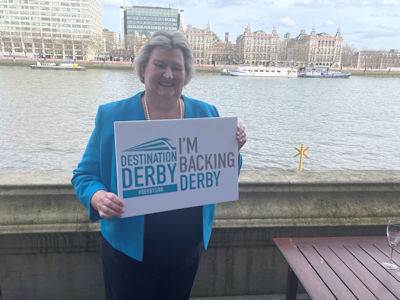 Heather Wheeler MP holding an 'I'm backing Derby' sign