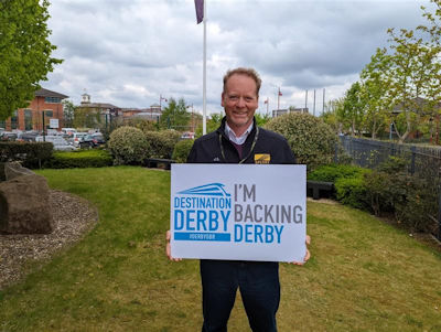 Justin Stroud holding an 'I'm backing Derby' sign
