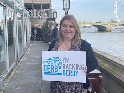Karen Bradley MP holding an 'I'm backing Derby' sign