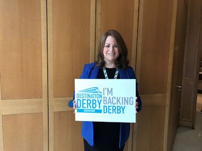Kate Griffiths MP holding an 'I'm backing Derby' sign