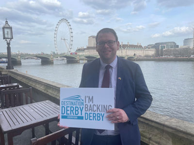 Mark Fletcher MP holding an 'I'm backing Derby' sign