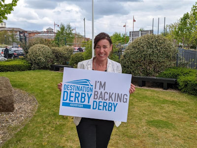 Sarah Devonport holding an 'I'm backing Derby' sign