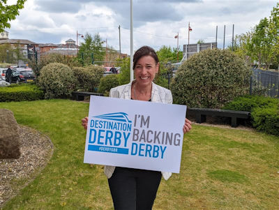 Sarah Devonport holding an 'I'm backing Derby' sign