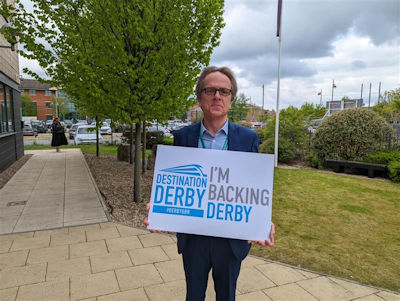 Tim Bagshaw holding an 'I'm backing Derby' sign