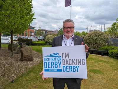 Tony Tinley holding an 'I'm backing Derby' sign