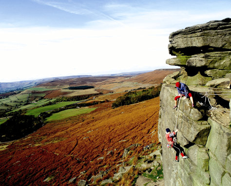 Two people rock climbing in the Peak District