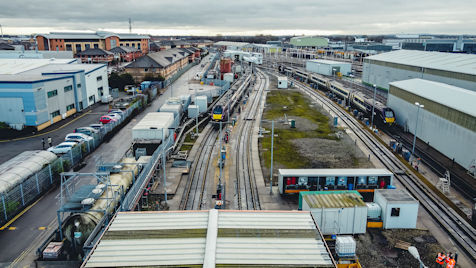 Aerial view of train approaching a train shed